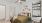 Carpeted one-bedroom with large bed, modern wall decor, ladder desk, desk chair, and en suite bathroom in Downtown Fort Worth